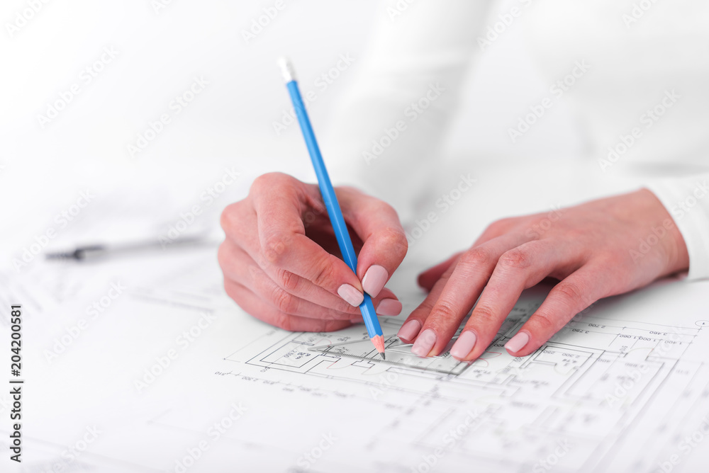 Engineer works with drawings. Engineer works with drawings.