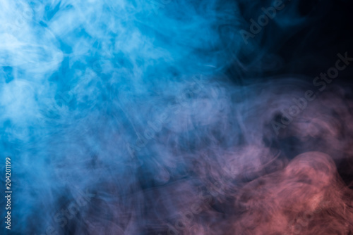 Abstract blue and pink smoke on a dark background