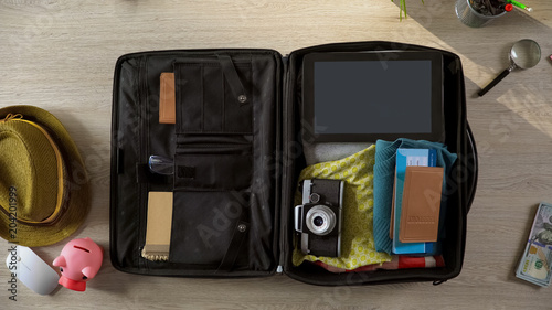 Documents and airplane tickets packed in suitcase, preparations for vacation