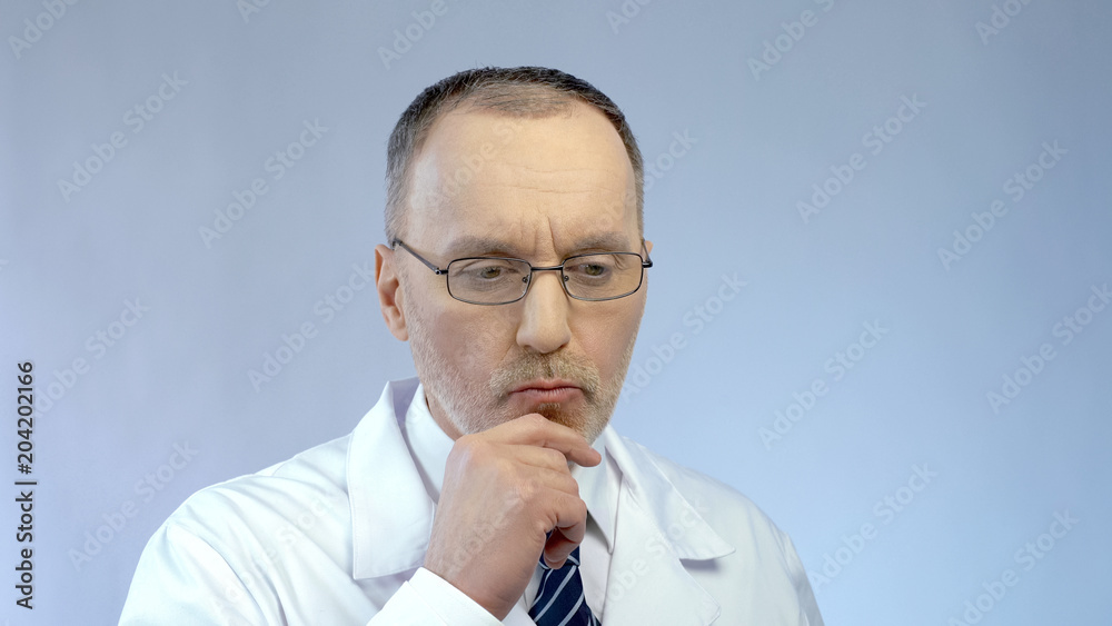 Male scientist thinking over project, solving problem in medical research Male scientist thinking over project, solving problem in medical research