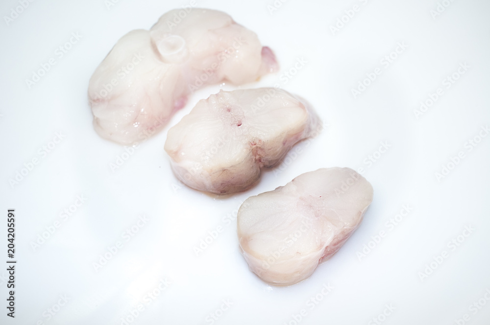 Monkfish tail steaks. Isolated over white