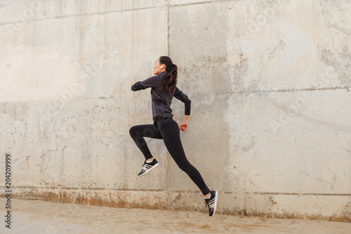 Amazing beautiful young asian sports woman running
