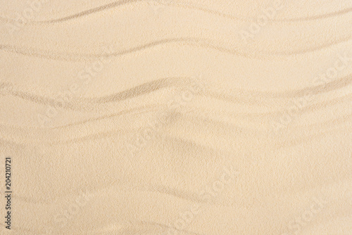 Texture of sandy beach with smooth waves