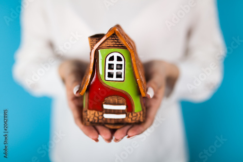 Female hands holding a toy house