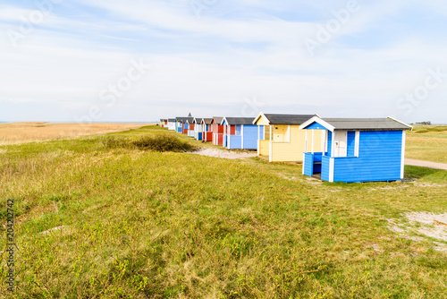 Skanor, Sweden - Long row of colorful bathing sheds along the coast.