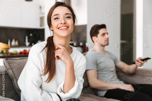 Portrait of a happy young woman sitting with her boyfriend