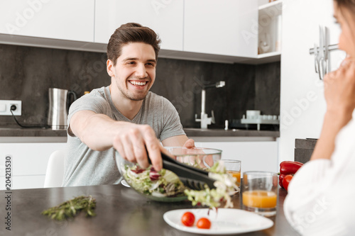 Portrait of a happy young man having healthy breakfast