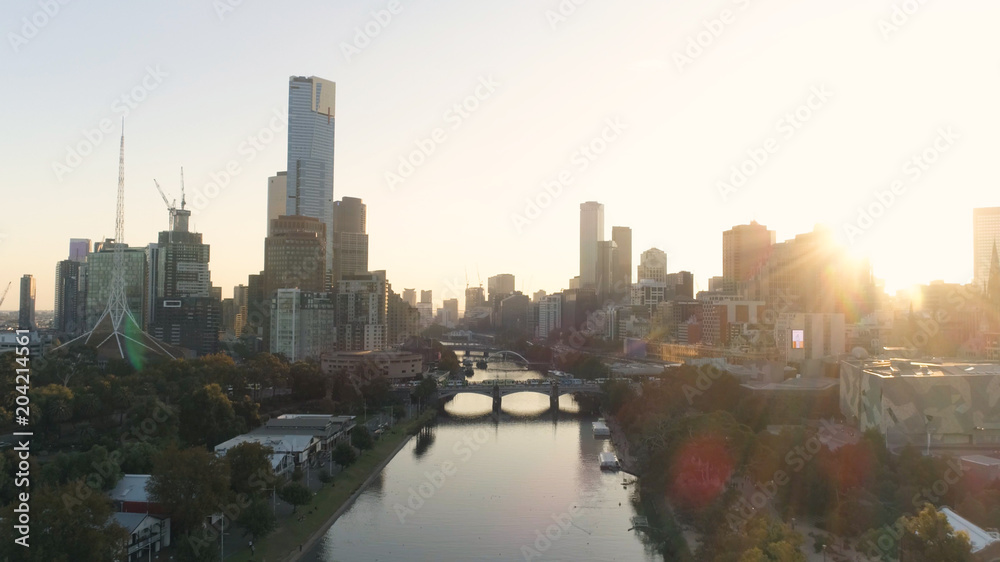 AERIAL. Scenery sunset in Melbourne downtown, above Yarra river