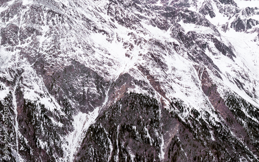 Naklejka premium Winter Alpine background. The mountainous terrain in the snow