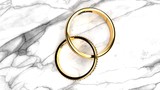 Forever together wedding rings with engraved word 'forever' on a white marble table, symbolize love and staying forever together, close up