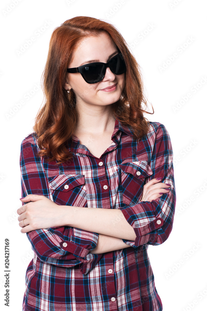 Young girl smiling with arms crossed in plaid shirt Young girl smiling with arms crossed in plaid shirt