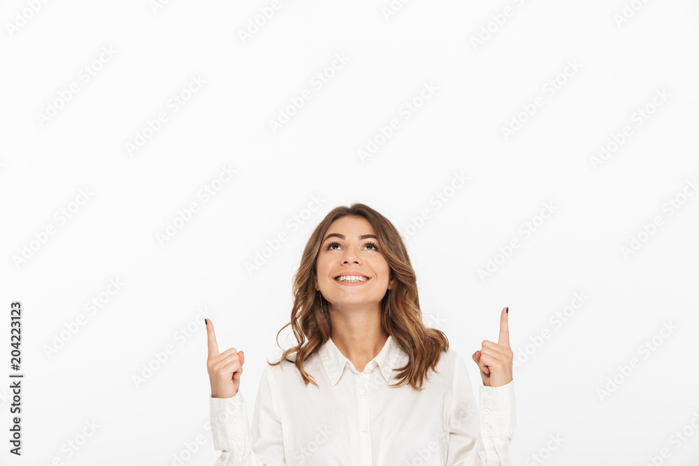 Portrait of a smiling young business woman pointing fingers Portrait of a smiling young business woman pointing fingers
