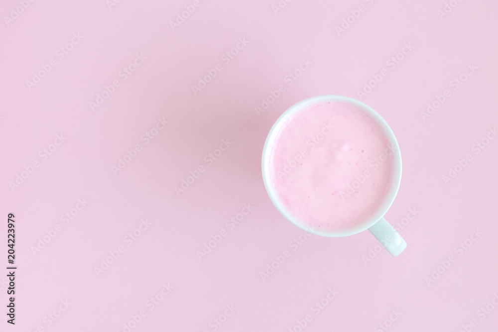 High angle view of cup of fruit smoothie on rose background. High angle view of cup of fruit smoothie on rose background.