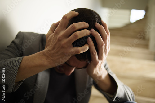 desperate man with his hands in his head