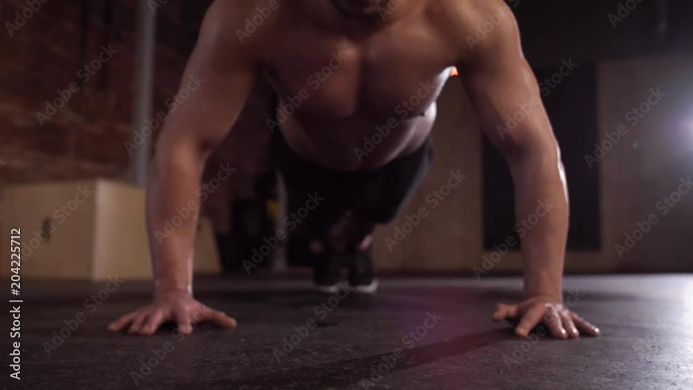 Muscular man doing push ups