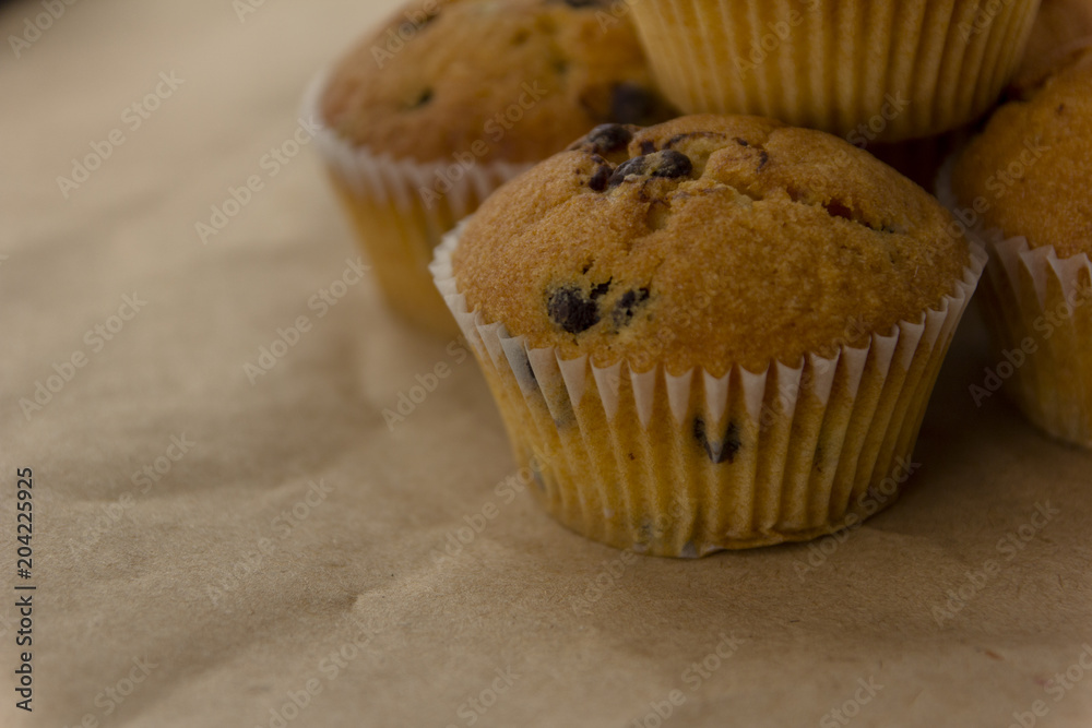 Homemade cupcakes with chocolate lit by the morning sun from the window. Homemade cupcakes with chocolate lit by the morning sun from the window.