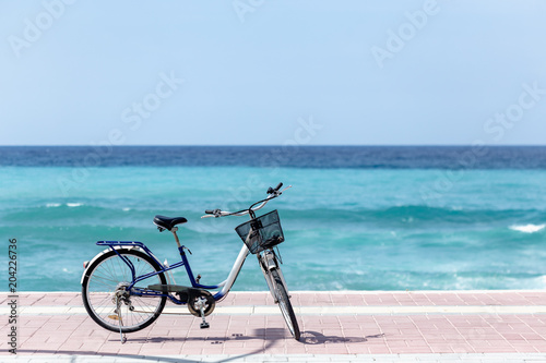 Summer outdoor activities. Bicycle standing by the sea.