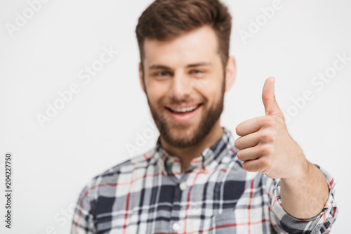 Portrait of a happy young man in plaid shirt