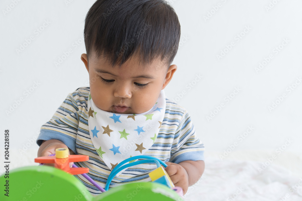 Cute asian baby sitting and play wooden toys Cute asian baby sitting and play wooden toys