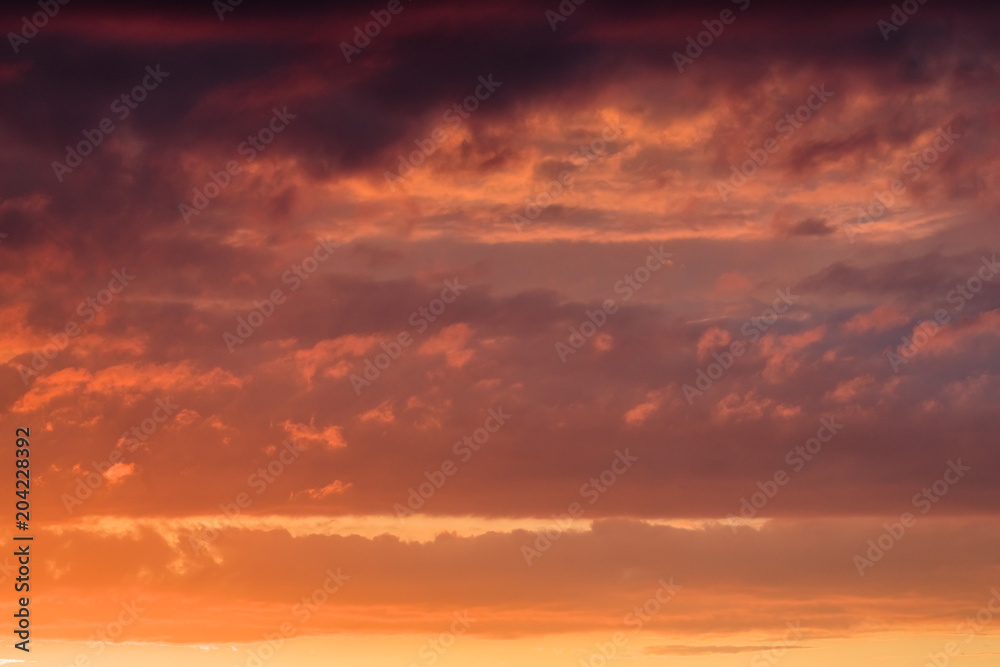 Orange clouds on the sky at the sunset moment