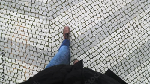 POV point of view perspective of person wearing boots and walking in medieval coblestones in europe photo