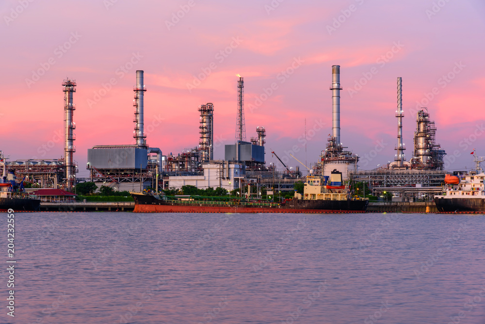 Oil refinery at the river in sunset time Oil refinery at the river in sunset time
