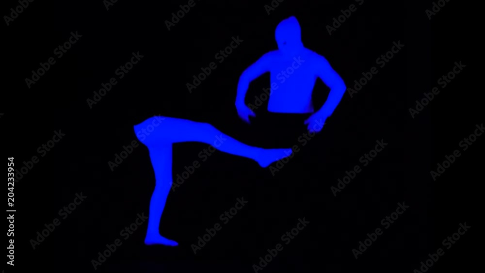 Ultraviolet Bottom and Top Halves - Legs and Torso Pantomime Interaction. Legs are Kick the Bounces Body. Monochrome - Blue on Black Scene in Black Light. Ultraviolet Bottom and Top Halves - Legs and Torso Pantomime Interaction. Legs are Kick the Bounces Body. Monochrome - Blue on Black Scene in Black Light.