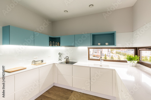 Iilluminated modern white turquoise kitchen
