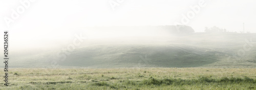 A Hilly Field In The Fog At Dawn In The Early Morning. Countryside Of Russia. Panorama HD. photo