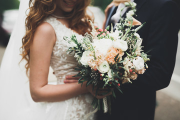 Beauty wedding bouquet with different flowers in hands