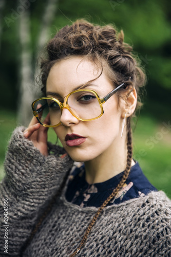 Pretty young woman with eyeglasses in the forest