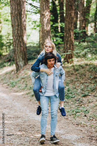 Happy young couple having fun in forest