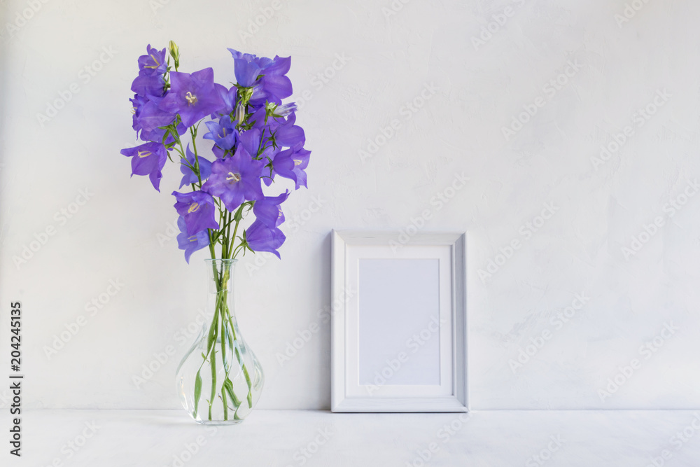 Mockup with a white frame and summer blue flowers Mockup with a white frame and summer blue flowers