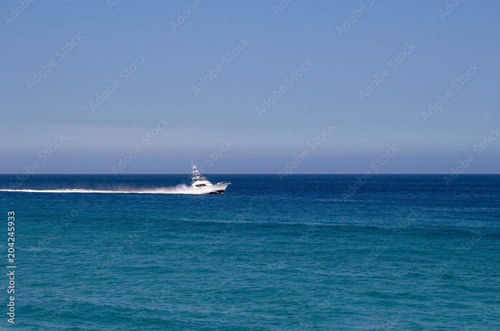 Yacht traveling in the open blue ocean and blue sky in Mexico