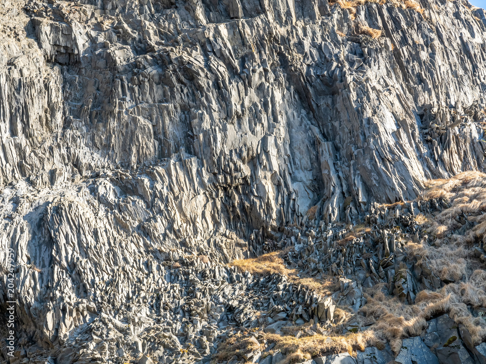 Fototapeta premium Basalt rock mountain near black sand beach in Iceland