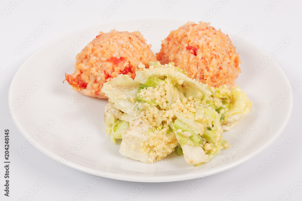 Tomato rice and salad on a white Tomato rice and salad on a white
