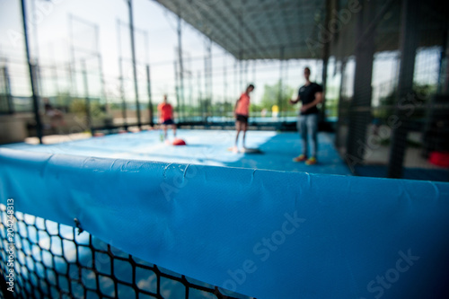 paddle tennis players training on court