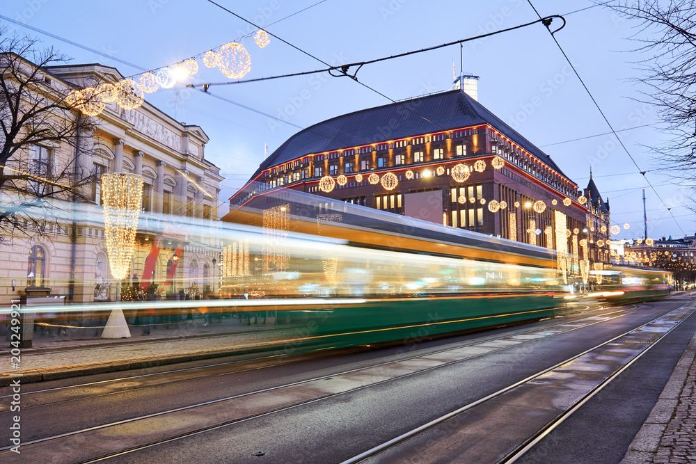 Moving tram in center of Helsinki on the background of the Stockmann department store