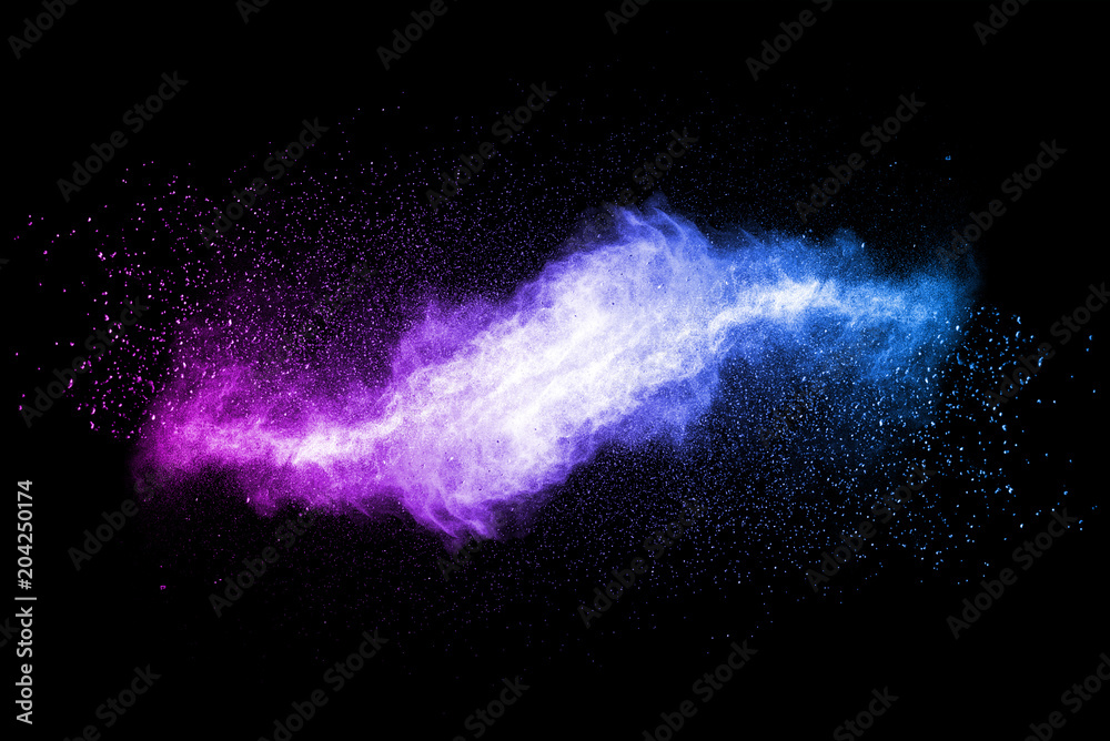 Fototapeta Explosion of multicolored dust on black background.