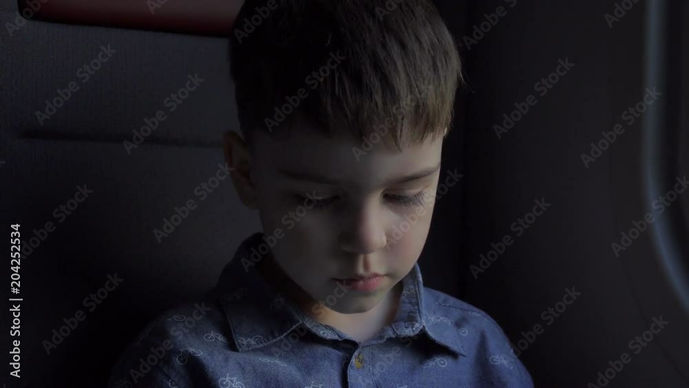 A close-up of a boy who travels in transport carefully what he is considering A close-up of a boy who travels in transport carefully what he is considering