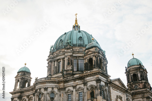 The Berlin Cathedral is called Berliner Dom. Beautiful old building in the style of neoclassicism and baroque with cross and sculptures.