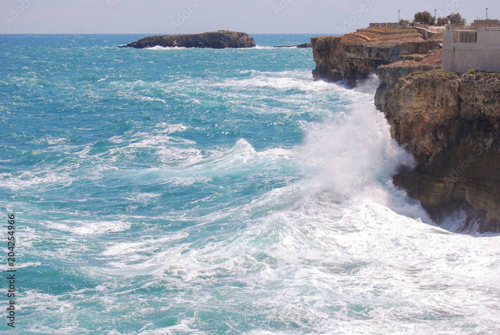 View of cliff of Polignano a Mare with rough sea
