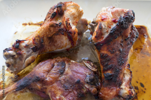 Appetizing grilled turkey shanks and chicken legs