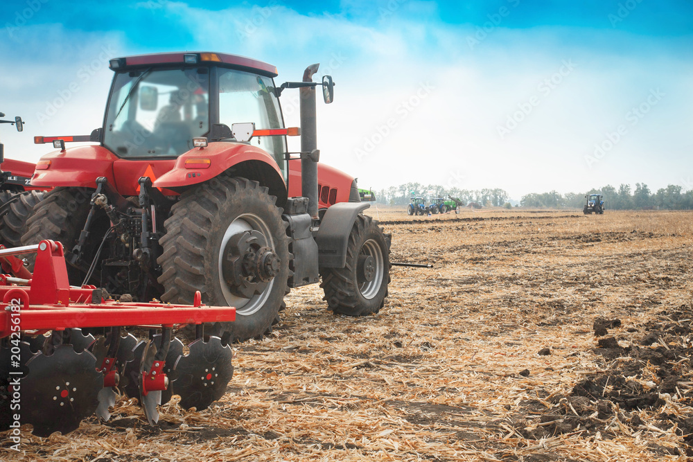 Red tractor in the field on a bright sunny day. Red tractor in the field on a bright sunny day.