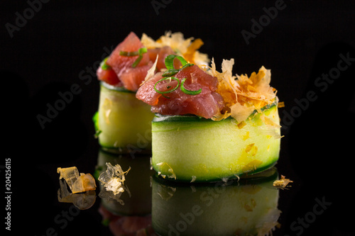 gunkan maki with tuna - sushi on the black background