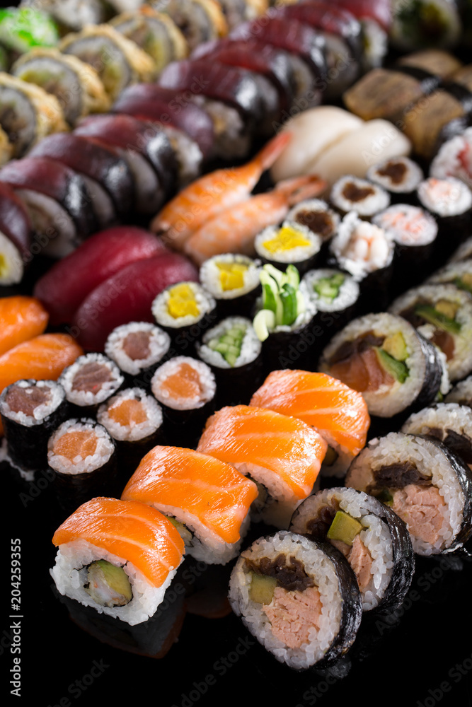 large sushi set on the black background large sushi set on the black background