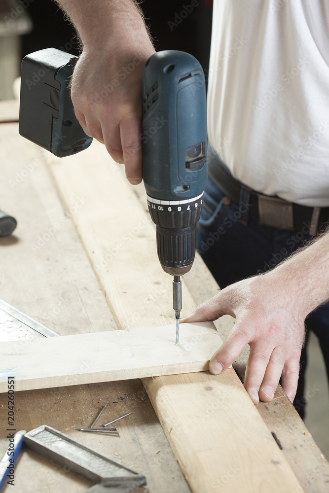 carpenter using electric drill