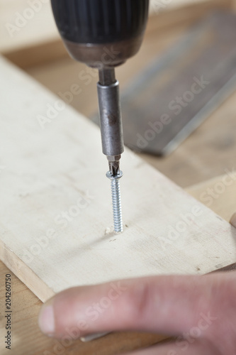 carpenter using electric drill