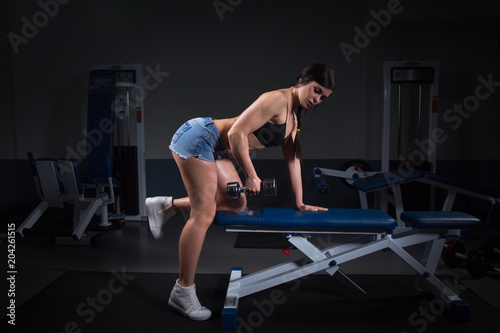 woman exercising dumbbell row at the gym. fitness. halthy concept