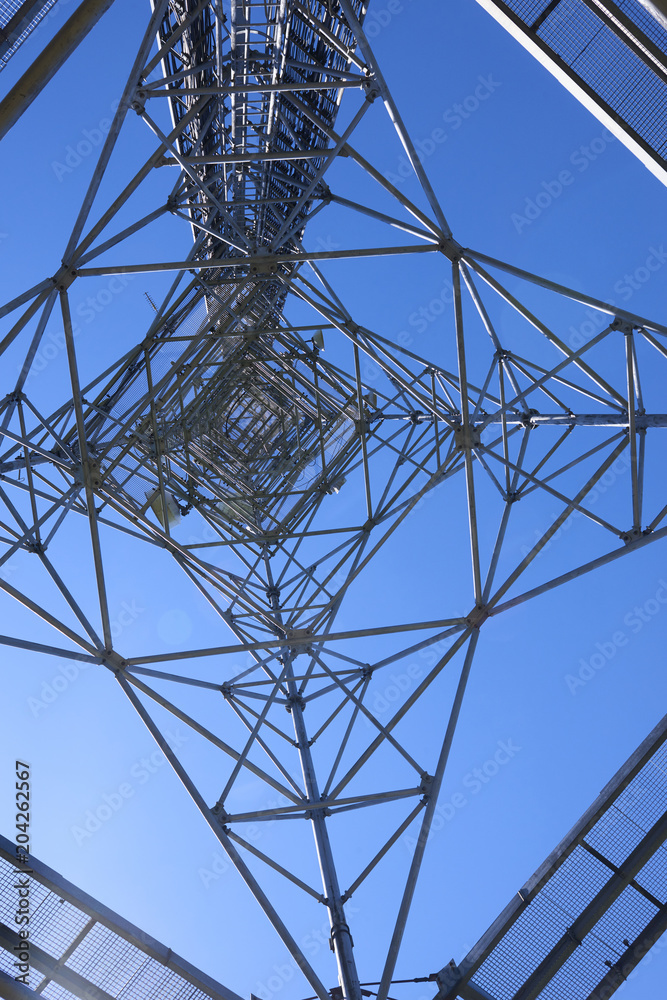  Telecommunication tower with antennas against the blue sky
